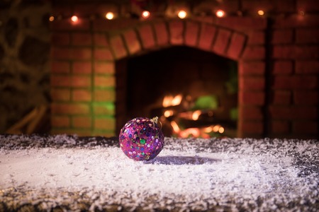Christmas Room Interior Design, Closeup view of Christmas decorations on table with snow and fireplace on background. Empty space for your text. Selective focus
