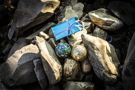 Christmas and New Year concept. Holiday decor elements on golden stones. Empty space. No snowの写真素材