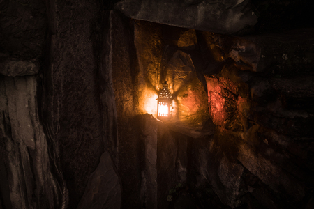 Beautiful colorful illuminated lamp in the garden in misty night. Retro style lantern at night...