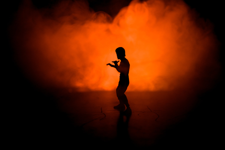 Karate athletes fighting scene.Character karate. Posing figure artwork decoration. Sports Scramble or Man practicing karate on decorated foggy background with light.の写真素材