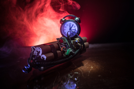 Image of a time bomb against dark background. Timer counting down to detonation illuminated in a...