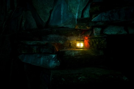 Beautiful colorful illuminated lamp in the garden in misty night. Retro style lantern at night outdoor. Selective focusの写真素材