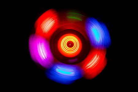 Music Dj concept. Trail of fire and smoke on vinyl record. Burning vinyl disk. Turntable vinyl record player on dark background. Selective focusの写真素材