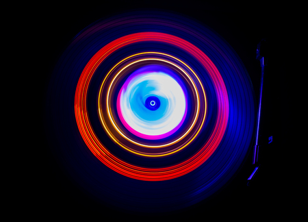 Music Dj concept. Trail of fire and smoke on vinyl record. Burning vinyl disk. Turntable vinyl record player on dark background. Selective focusの写真素材