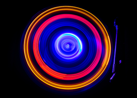 Music Dj concept. Trail of fire and smoke on vinyl record. Burning vinyl disk. Turntable vinyl record player on dark background. Selective focusの写真素材