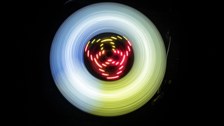 Music Dj concept. Trail of fire and smoke on vinyl record. Burning vinyl disk. Turntable vinyl record player on dark background. Selective focusの写真素材