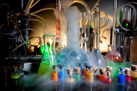 Pharmacy and chemistry theme. Test glass flask with solution in research laboratory. Science and...