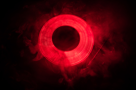 Music Dj concept. Trail of fire and smoke on vinyl record. Burning vinyl disk. Turntable vinyl...