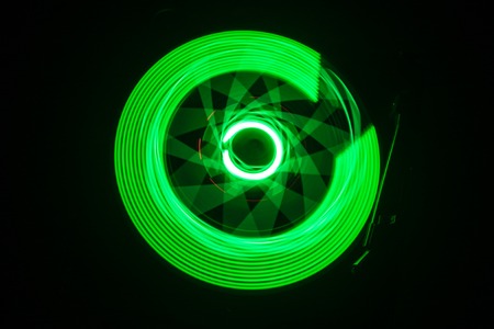 Music Dj concept. Trail of fire and smoke on vinyl record. Burning vinyl disk. Turntable vinyl record player on dark background. Selective focusの写真素材