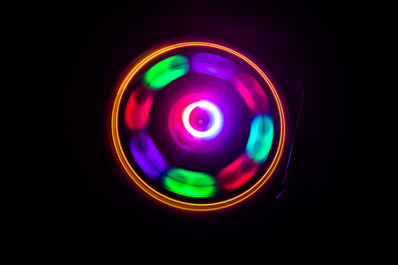 Music Dj concept. Trail of fire and smoke on vinyl record. Burning vinyl disk. Turntable vinyl record player on dark background. Selective focusの写真素材