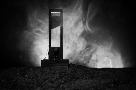 Horror view of Guillotine. Human at guillotine on a dark foggy background. Execution conceptの写真素材