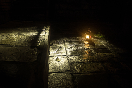Beautiful colorful illuminated lamp in the garden in misty night. Retro style lantern at night outdoor. Selective focusの写真素材