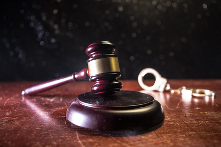 Law theme, mallet of the judge on wooden desk with Lady Justice Statue. Law gavel on dark foggy background with light. Selective focusの写真素材