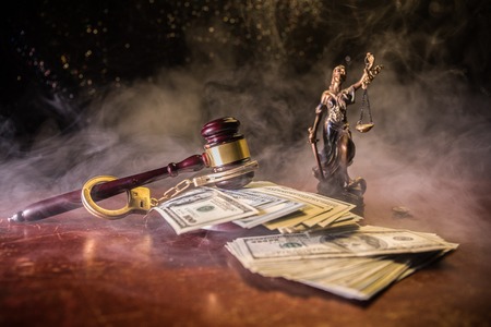 Law theme, mallet of the judge on wooden desk with Lady Justice Statue. Concept For Corruption, Justice, Law, Bankruptcy Court, Bail, Crime, Bribing, Fraud. Law gavel with handcuff and moneyの写真素材