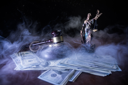 Law theme, mallet of the judge on wooden desk with Lady Justice Statue. Concept For Corruption, Justice, Law, Bankruptcy Court, Bail, Crime, Bribing, Fraud. Law gavel with handcuff and moneyの写真素材