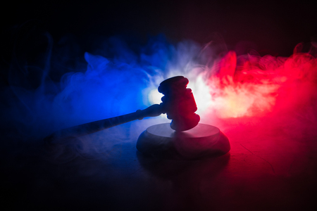 Law theme, mallet of the judge on wooden desk with Lady Justice Statue. Law gavel on dark foggy background with light. Selective focusの写真素材