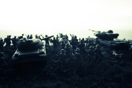 War Concept. Military silhouettes fighting scene on war fog sky background, World War Soldiers Silhouettes Below Cloudy Skyline at sunset. Attack scene. Armored vehicles. tank in actionの写真素材