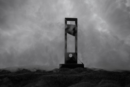 Horror view of Guillotine. Close-up of a guillotine on a dark foggy background. Execution conceptの写真素材