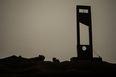 Horror view of Guillotine. Close-up of a guillotine on a dark foggy background. Execution conceptの写真素材