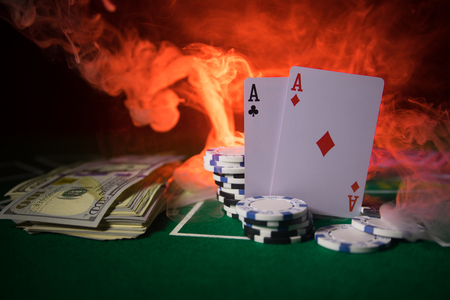Cards and chips on green felt casino table. Abstract background with copy space. Gambling, poker, casino and cards games theme. Casino elements on green. Selective focusの写真素材