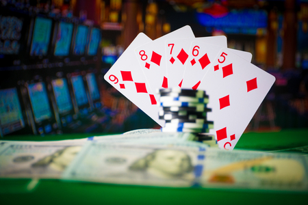 Cards and chips on green felt casino table. Abstract background with copy space. Gambling, poker,...