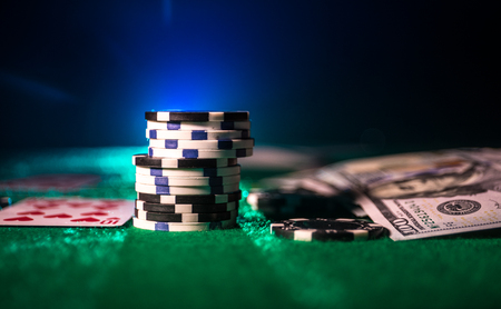 Cards and chips on green felt casino table. Abstract background with copy space. Gambling, poker,...