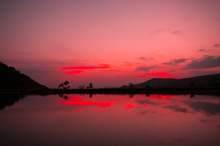 Beautiful clouds flying over the lake near mountains. Evening time shot over the clouds. Azerbaijan. Big Caucasus. Nobodyの写真素材