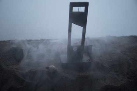 Horror view of Guillotine. Close-up of a guillotine on a dark foggy background. Execution concept