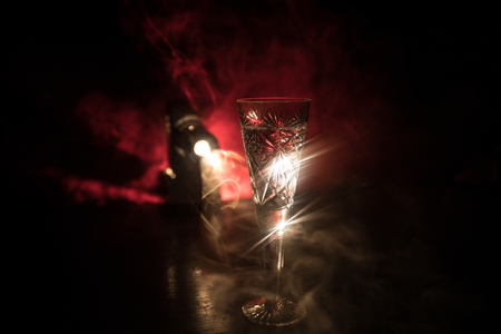 Closeup wine glass with fog at dark background. Beautiful glass with smoke and light. Selective focusの写真素材