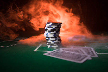 Cards and chips on green felt casino table. Abstract background with copy space. Gambling, poker, casino and cards games theme. Casino elements on green. Selective focusの写真素材