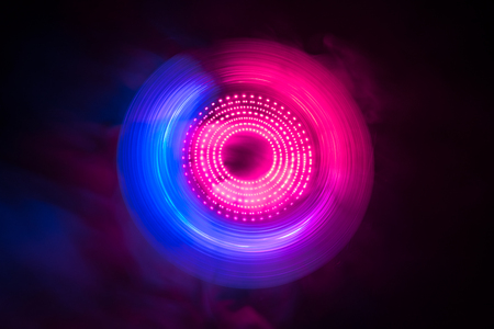 Music Dj concept. Trail of fire and smoke on vinyl record. Burning vinyl disk. Turntable vinyl record player on dark background. Selective focusの写真素材