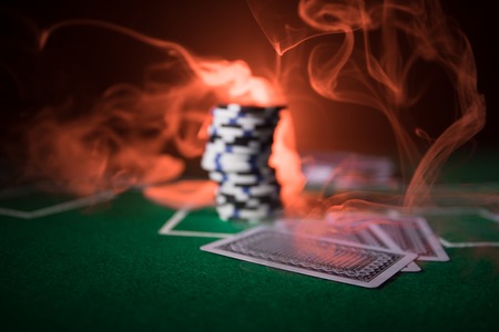 Cards and chips on green felt casino table. Abstract background with copy space. Gambling, poker,...