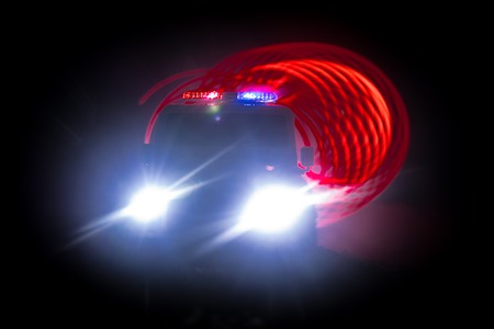 Police cars at night. Police car chasing a car at night with fog background. 911 Emergency response...