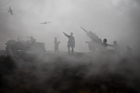 An anti-aircraft cannon and Military silhouettes fighting scene on war fog sky background. Allied air forces attacking on German positions. Artwork decorated scene. Selective focusの写真素材