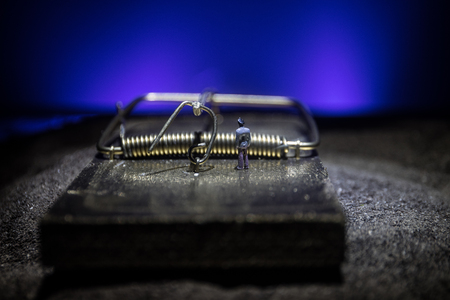 Creative concept. Artwork decoration of mousetrap in sand on dark toned foggy background. Mousetrap...