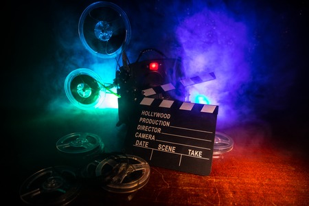 Old vintage movie projector on a dark background with fog and light. Concept of film-making. Selective focusの写真素材