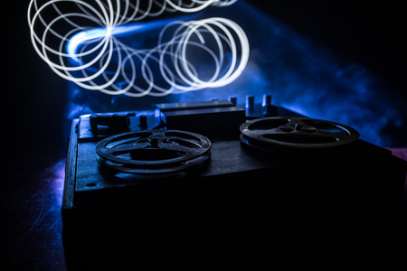 Old vintage reel to reel player and recorder on dark toned foggy background. Analog Stereo Open Reel Tape Deck Recorder Player with Reels. Selective focusの写真素材