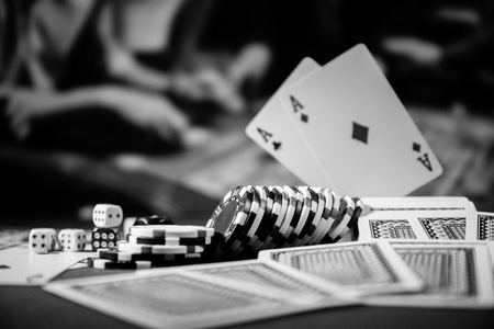 Cards and chips on green felt casino table. Abstract background with copy space. Gambling, poker, casino and cards games theme. Casino elements on green. Selective focusの写真素材