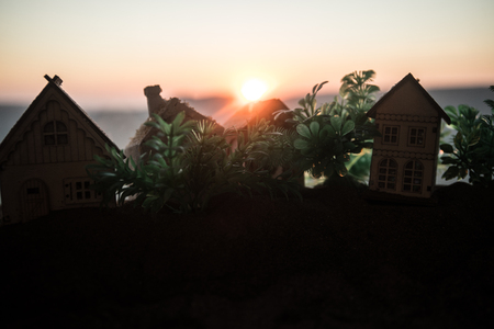 Artwork Decoration. Beautiful decorative small wooden houses on sunset background. Selective focusの写真素材