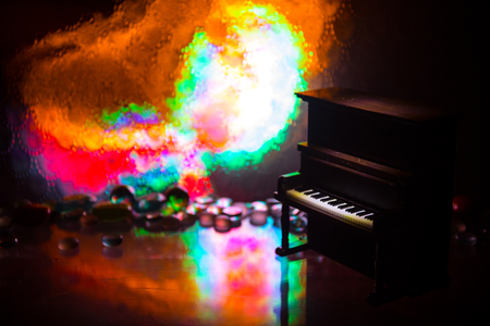 Creative concept. Artwork decoration with piano on dark toned foggy background with light. Selective focusの写真素材