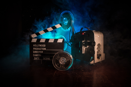 Old vintage movie projector on a dark background with fog and light. Concept of film-making. Selective focusの写真素材
