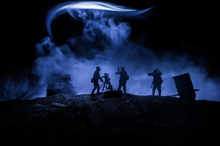 War Concept. Military silhouettes fighting scene on war fog sky background, World War Soldiers Silhouette Below Cloudy Skyline At night.の写真素材