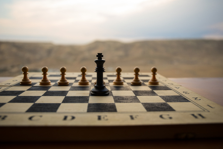 Chess board game concept of business ideas and competition. Chess figures on a chessboard. Outdoor sunset background. Selective focusの写真素材