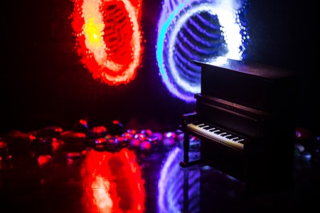 Creative concept. Artwork decoration with piano on dark toned foggy background with light. Selective focusの写真素材