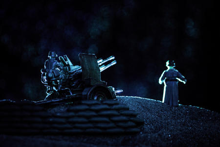 War Concept. Military silhouettes fighting scene on war fog sky background, World War Soldiers Silhouette Below Cloudy Skyline At night.の写真素材