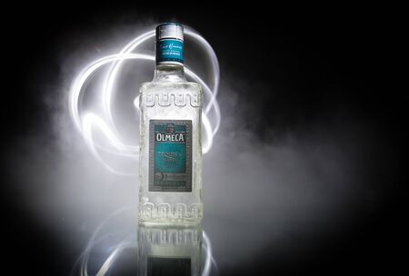 Baku, Azerbaijan - JUNE 16. 2019. Olmeca Tequila on wooden table on a dark toned foggy background. Olmeca Tequila is a tequila produced in Jalisco, Mexico. Olmeca is owned by the Pernod Ricard Group.のeditorial素材