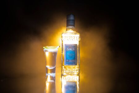 Baku, Azerbaijan - JUNE 16. 2019. Olmeca Tequila on wooden table on a dark toned foggy background. Olmeca Tequila is a tequila produced in Jalisco, Mexico. Olmeca is owned by the Pernod Ricard Group.のeditorial素材