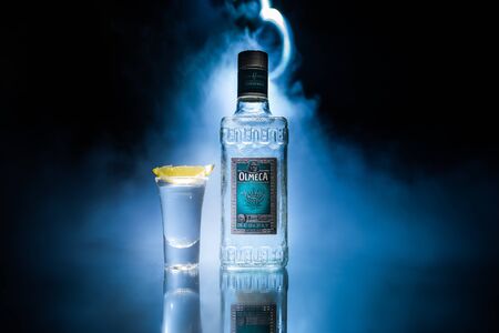Baku, Azerbaijan - JUNE 16. 2019. Olmeca Tequila on wooden table on a dark toned foggy background. Olmeca Tequila is a tequila produced in Jalisco, Mexico. Olmeca is owned by the Pernod Ricard Group.のeditorial素材