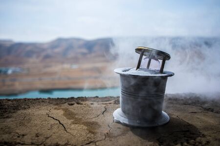 A concept of frozen time. Hourglass in ice. Creative artwork decoration. Selective focus