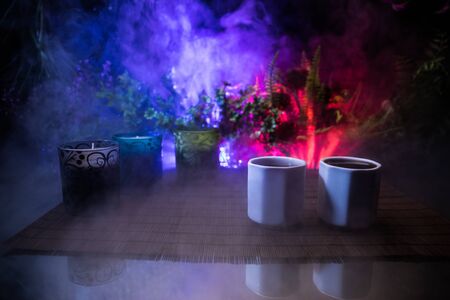 Tea concept. Japanese tea ceremony culture east beverage. Teapot and cups on table with bamboo and...